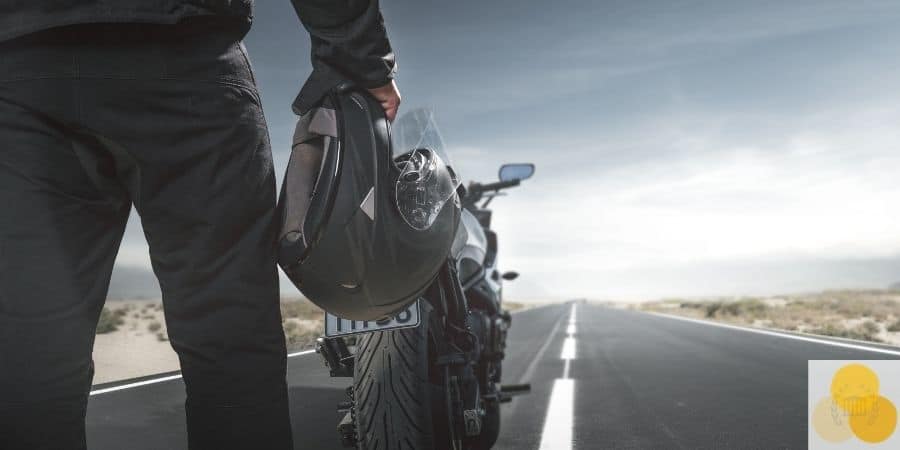 man holding motorcycle helmet